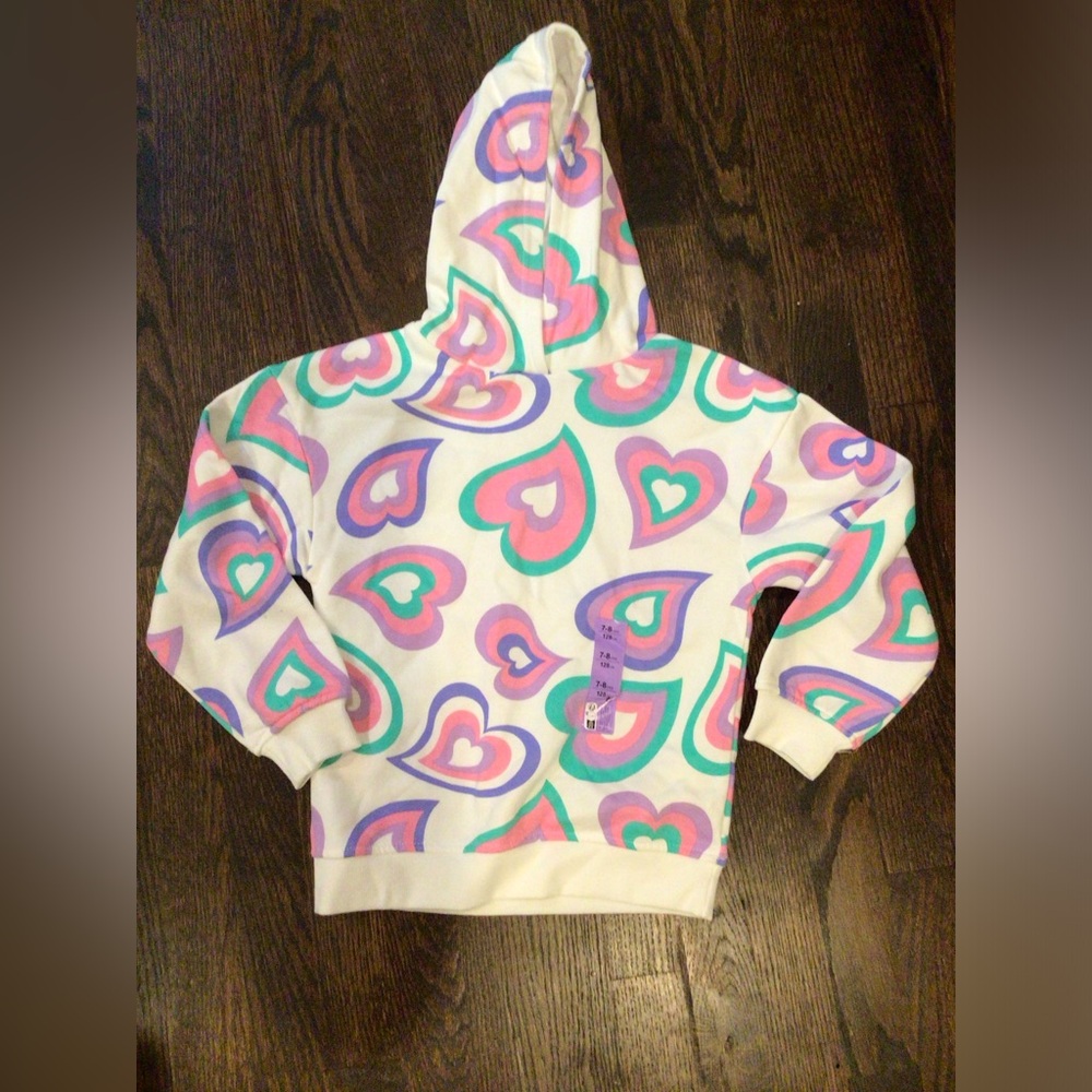 Primark - Girl’s hoodie features a vibrant, multicolored heart pattern